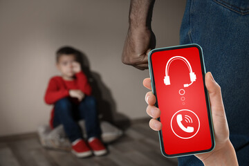 Woman calling domestic violence hotline to prevent aggression upon little boy