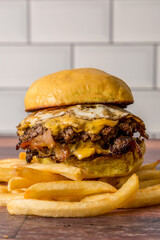 homemade burgers with cheese bacon egg and fries ready to eat