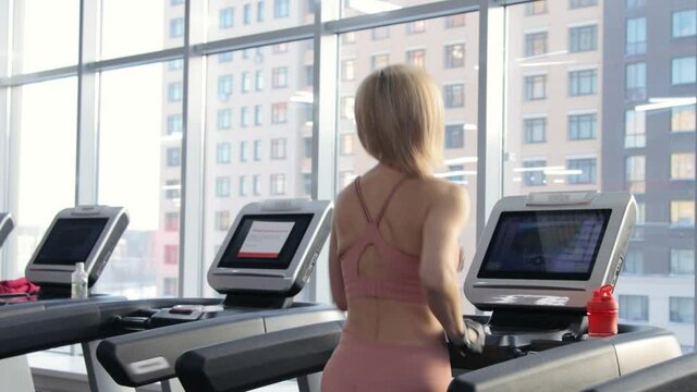 Young woman training on treadmill