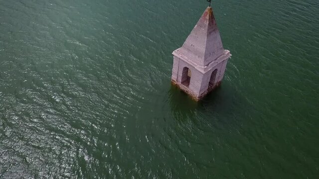 Aerial Panning: Church Tower On Reservoir During Sunny Day