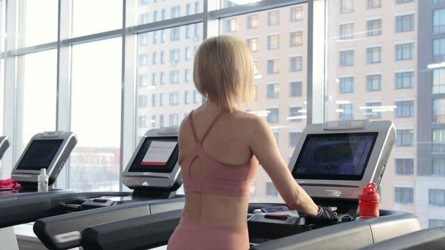 Young woman training on treadmill