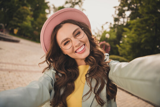 Photo of charming positive girl make selfie beaming smile have good mood spend free time park outdoors