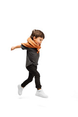 Jumping high. Happy, smiley little caucasian boy isolated on white studio background with copyspace for ad. Looks happy, cheerful. Childhood, education, human emotions, facial expression concept.