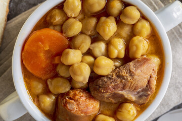 Chickpea stew dish (Madrid stew). With beef, chorizo, bacon, carrots and olive oil. Mediterranean...