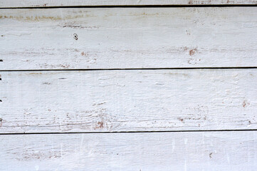 Obraz na płótnie Canvas Gray wood plank wall with old paint. Old and beautiful background. Natural pattern for design. Grunge background. Peeling paint on an old wooden wall. Rustic style wallpaper. Timber texture