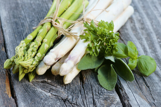 White and green asparagus with herbs, copy space