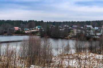 Fototapeta premium Russia, Lodeinoe Pole, December 2020. A village on the shore of a lake near an Orthodox monastery.