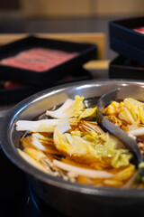 Slices of vegetable boiled in hot soupe and with of the high-grade beef background.