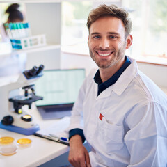 Smiling young male technician analyzing samples in a lab