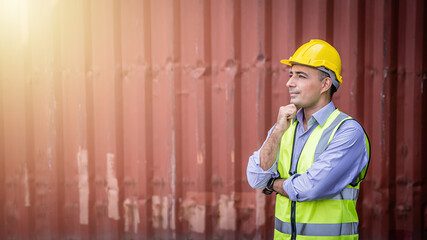 Confident Middle-eastern male engineer portrait in uniform standing in front of the container. Logistics and shipping. Professional occupation.