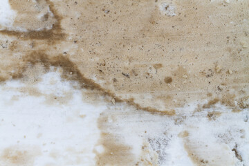 The texture of dirty snow on the road leveled by a bulldozer bucket