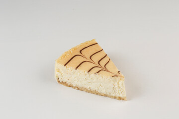 A piece of cheesecake on a white background, isolate. A delicious dessert for a birthday and holiday.