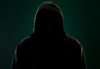 dark portrait of a hidden person on a green background