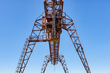 Industrial crane, lift, forklift a sawmill outdoors. Timber loading Gantry crane.