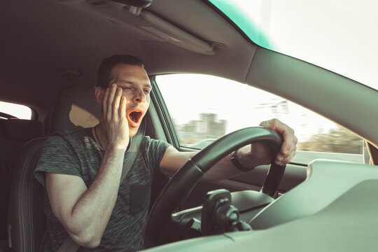 Drunk driver yawning and falling asleep rushes at high speed along road, breaking the rules and speeding violation. Drug intoxication while driving in motion. Problems and risk of accident