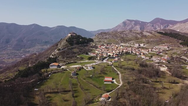 Aerial panoramic landscape view of Pietraroja, a hill top village in Italy, on a bright sunny day