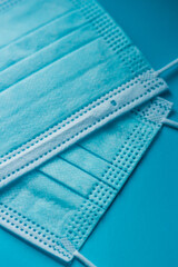 protective medical masks of blue color close-up on a blue background	