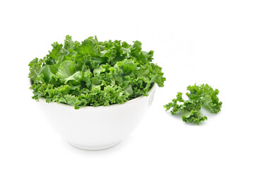 Kale leaves in a bowl isolated on white background