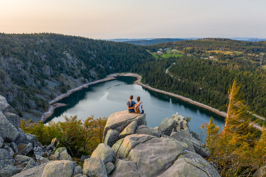 Aerial view of couple overlooking lake Blanc in Haut-Rhin region, France.