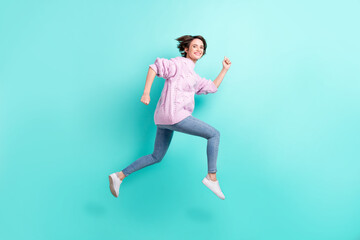 Fototapeta na wymiar Full length photo of shiny cute young woman wear violet sweater running jumping isolated turquoise color background