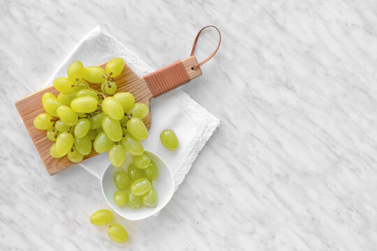 Ripe green grapes on white background