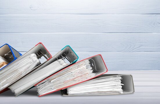 File folders with paper documents on the desk