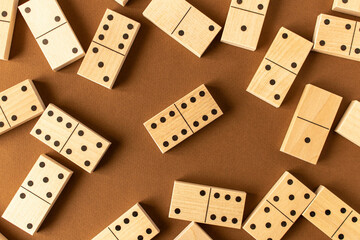 A game of dominoes on a brown background. Close-up. Selective focus.