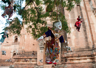 Fototapeta na wymiar Traditional dolls hanging in trees at a temple in Bagan, Myanmar (Burma), Asia
