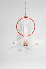 Little acrobat girl shows an acrobatic performance on an aerial hoop © Rychko Yevhen