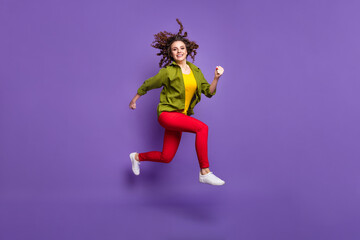 Fototapeta na wymiar Full size photo of young happy positive smiling attractive lovely girl running in air isolated on purple color background