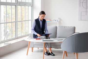 Portrait of female psychologist sitting on sofa in office