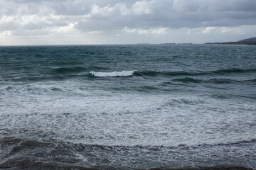 Naklejka na ściany i meble Foam at the shore from the sea wave
