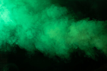 Fototapeta na wymiar Texture of green smoke on a black background