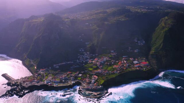 Cinematic aerial view of Poto Moniz with beautiful mountain landscape and city in the valley. Madeira Island,Europe.