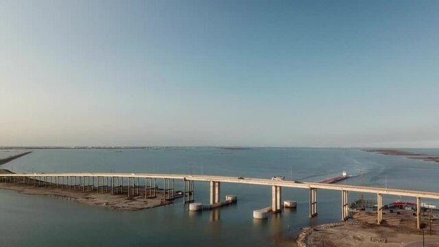 Aerial approach of the bridge over the Gulf Intercoastal Waterway shipping channel on JFK Causeway at southern end of Corpus Christi Bay in Texas Texas
