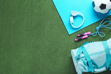 Composition with bag and sports equipment on color background