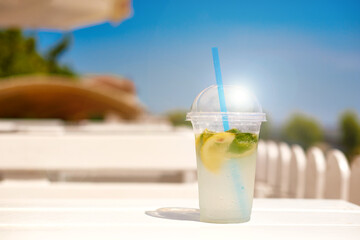 ice invigoration summer drink on white wooden table on open terrace. concept cool refreshing lemonade for quench thirst