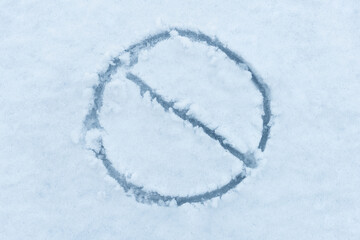 Stop sign is drawn on the white snow. Danger on winter road concept.