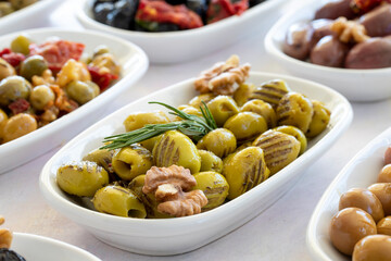 varieties of olives on the plate on a white background