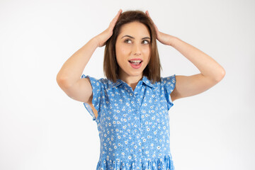 Close-up portrait of young pretty surprised woman with opened mouth standing with open palms, isolated over white background