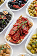 varieties of olives on the plate on a white background