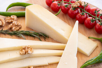 Close-up old cheddar on wooden background. Local name eski kaşar peynir