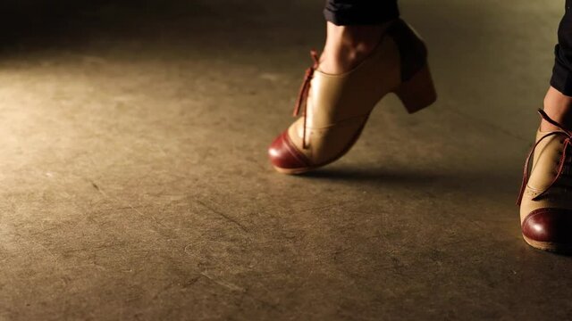 closeup of a woman flamenco shoes turn a round muster in the floor