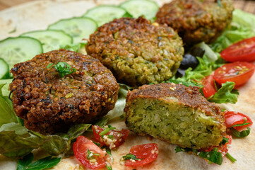 Homemade falafel on pita bread with tomatoes, cucumber and lettuce