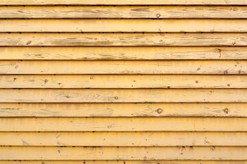 Wall made of  yellow painted wooden planks