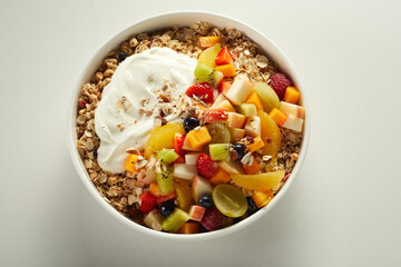 Bowl with delicious muesli on white table