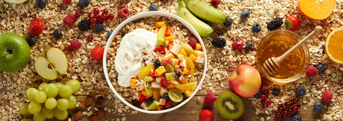 Healthy muesli in bowl on table with fruits and berries
