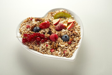 Heart shaped bowl of healthy muesli