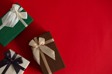 Gift box with bow on red background. Horizontal with copy space.
