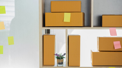 Cardboard boxes at work, small business entrepreneurs, SMEs, also work with boxes at home, selling e-commerce ideas online.